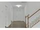 Bright foyer with hardwood floors, staircase and white front door at 4821 Heathshire Dr, Raleigh, NC 27616