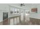 Open-concept living room with a fireplace and access to the back patio at 4821 Heathshire Dr, Raleigh, NC 27616