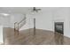 Bright, open living room features hardwood floors, fireplace, and ceiling fan at 4821 Heathshire Dr, Raleigh, NC 27616