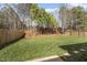 Well-maintained backyard featuring lush green grass and a wooded area at 500 Skygrove Dr, Holly Springs, NC 27540