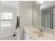 Bathroom featuring a sink, a window, and a shower with a curtain at 500 Skygrove Dr, Holly Springs, NC 27540