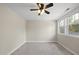 Bedroom showcasing carpet floors, a ceiling fan, and natural light at 500 Skygrove Dr, Holly Springs, NC 27540