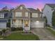Stunning exterior of a two-story home with a welcoming porch and well-manicured landscaping at 500 Skygrove Dr, Holly Springs, NC 27540