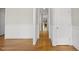Hallway with hardwood floors and wainscoting that provides access to other rooms at 500 Skygrove Dr, Holly Springs, NC 27540