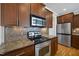 The well-equipped kitchen showcases stainless steel appliances and beautiful wooden cabinetry at 500 Skygrove Dr, Holly Springs, NC 27540
