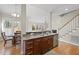 Kitchen view showcasing countertops, cabinets, stainless dishwasher, and adjacent breakfast nook at 500 Skygrove Dr, Holly Springs, NC 27540