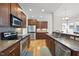 Modern kitchen featuring stainless steel appliances, wood cabinets, and sleek countertops at 500 Skygrove Dr, Holly Springs, NC 27540