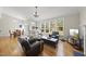 Sunlit living room showcases hardwood floors, a fireplace, and ample seating at 500 Skygrove Dr, Holly Springs, NC 27540