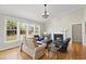 Cozy living room with fireplace, hardwood floors, and plenty of natural light from large windows at 500 Skygrove Dr, Holly Springs, NC 27540