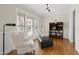 Bright living room area with beautiful hardwood floors, two chairs, and large windows at 500 Skygrove Dr, Holly Springs, NC 27540