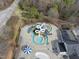 Aerial view of waterpark with slides, pools, and umbrella, perfect for community fun at 500 Skygrove Dr, Holly Springs, NC 27540