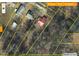 Aerial view of property with surrounding trees and structures. Property boundaries are marked in yellow at 510 Short W St, Hillsborough, NC 27278