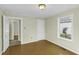 Bedroom with a window, neutral paint, and wood-look flooring at 510 Short W St, Hillsborough, NC 27278