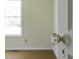 Bright bedroom featuring a classic glass doorknob, offering a view to the yard at 510 Short W St, Hillsborough, NC 27278
