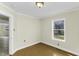 Bedroom with hardwood-look flooring, neutral paint, and window to yard at 510 Short W St, Hillsborough, NC 27278
