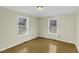 Bedroom with two windows, hardwood floor, and neutral paint at 510 Short W St, Hillsborough, NC 27278