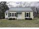 Charming home featuring a metal roof, complementary green shutters, and a well-maintained lawn at 510 Short W St, Hillsborough, NC 27278