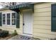 Charming home entrance featuring a white door, matching trim, and complementary green awning and shutters at 510 Short W St, Hillsborough, NC 27278