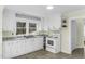 Well-lit kitchen features white cabinets and updated appliances at 510 Short W St, Hillsborough, NC 27278