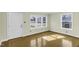 Bright living room with multiple windows providing ample natural light and hardwood flooring at 510 Short W St, Hillsborough, NC 27278
