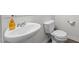 Cozy half bath featuring a pedestal sink, modern toilet, and chrome fixtures at 538 E Waycliff Rd, Henderson, NC 27537