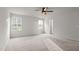 Bedroom featuring neutral walls, carpeted floor, ceiling fan, and two windows at 538 E Waycliff Rd, Henderson, NC 27537