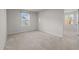 Bedroom featuring neutral walls, carpeted floor, and two windows at 538 E Waycliff Rd, Henderson, NC 27537