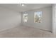 Spacious bedroom with neutral carpet and natural light from two windows at 538 E Waycliff Rd, Henderson, NC 27537