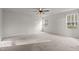 Spacious bedroom featuring neutral walls, carpeted floor, and two windows at 538 E Waycliff Rd, Henderson, NC 27537