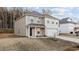 A beige two-story home featuring an attached garage and a small front yard at 538 E Waycliff Rd, Henderson, NC 27537