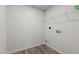 Functional laundry room with shelving, hookups, and durable wood-look flooring at 538 E Waycliff Rd, Henderson, NC 27537