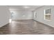 Bright living room featuring wood-look flooring and multiple windows for natural light at 538 E Waycliff Rd, Henderson, NC 27537