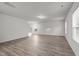 Bright living room with wood-look flooring, stairs, and multiple windows for natural light at 538 E Waycliff Rd, Henderson, NC 27537