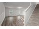 Large living room with LVP flooring, white walls, and staircase at 538 E Waycliff Rd, Henderson, NC 27537