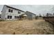 View of the home's unfinished backyard and covered porch at 544 Jocund St # 16, Rolesville, NC 27571