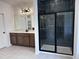 Bathroom featuring shower with glass, dark tile, and double sink vanity with countertop at 548 Jocund St # 15, Rolesville, NC 27571