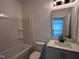 Well-lit bathroom with tub/shower and single sink with cabinet at 548 Jocund St # 15, Rolesville, NC 27571