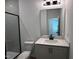 Modern bathroom with black framed glass shower door, white subway tile, and light countertop at 548 Jocund St # 15, Rolesville, NC 27571