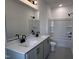 Bathroom featuring double sink with modern fixtures, white cabinets and tub/shower combo at 548 Jocund St # 15, Rolesville, NC 27571