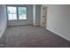A carpeted bedroom shows a window and door and is bathed in soft, natural light at 548 Jocund St # 15, Rolesville, NC 27571