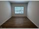 Bright bedroom features hardwood floors, fresh paint, and natural light from the window at 548 Jocund St # 15, Rolesville, NC 27571