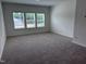 Large bedroom features plush carpet, fresh paint, and plenty of natural light from three windows at 548 Jocund St # 15, Rolesville, NC 27571