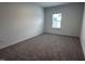 A carpeted bedroom features natural light and a neutral palette, creating a serene space at 548 Jocund St # 15, Rolesville, NC 27571