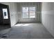Entryway with a window and an exterior door showing drywall and concrete flooring at 548 Jocund St # 15, Rolesville, NC 27571