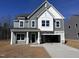 Two-story home with gray siding, white trim, and a spacious driveway leading to a two-car garage at 548 Jocund St # 15, Rolesville, NC 27571