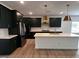 Open concept kitchen featuring dark cabinets, stainless steel appliances, and a spacious island at 548 Jocund St # 15, Rolesville, NC 27571