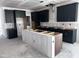 Kitchen showcasing dark cabinetry, a large island, and open space for appliances at 548 Jocund St # 15, Rolesville, NC 27571