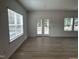 Sunlit living room featuring light-colored wood floors, windows and a glass door at 548 Jocund St # 15, Rolesville, NC 27571