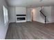 Expansive living room with a modern fireplace, staircase, and plenty of natural light at 548 Jocund St # 15, Rolesville, NC 27571