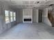 A spacious living room with fireplace and stairs is being prepared for finishing work at 548 Jocund St # 15, Rolesville, NC 27571